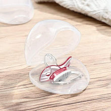Open clear pacifier case holding a red-and-white pacifier, hinged protective cover.