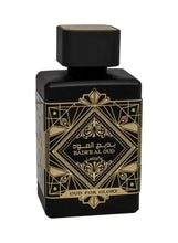 Perfume bottle, dark glass with gold geometric label and black cap