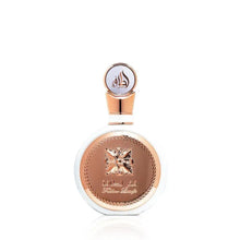 Round perfume bottle with rose-gold cap and gold floral emblem on the front