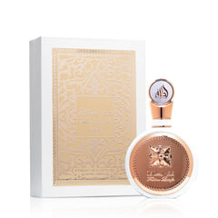 Lattafa Fakhar Women perfume bottle with elegant gold and white design next to matching decorative box