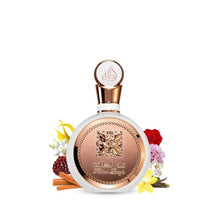 Round perfume bottle with rose-gold cap and gold emblem, with decorative flowers