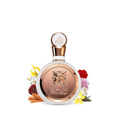 Lattafa Fakhar Women perfume bottle with golden ornate design surrounded by flowers and cinnamon sticks