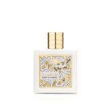 Gold-capped square perfume bottle with cream-and-gold ornate label