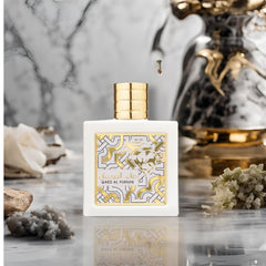 Lattafa Qaed al Fursan Unlimited perfume bottle with gold cap and intricate white and gold design