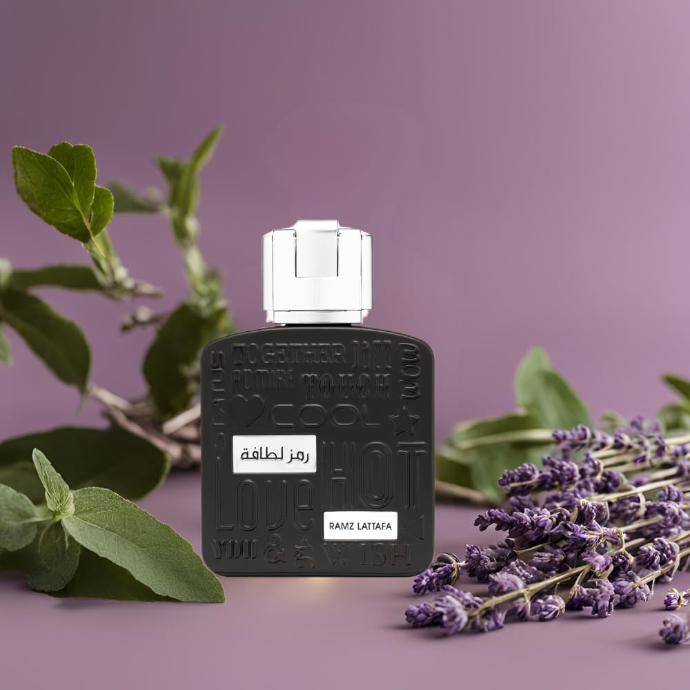 Lattafa Ramz Silver perfume bottle with silver cap placed next to lavender and green leaves on purple background