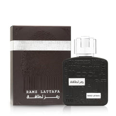 Lattafa Ramz Silver perfume bottle and dark brown packaging with embossed design and silver accents