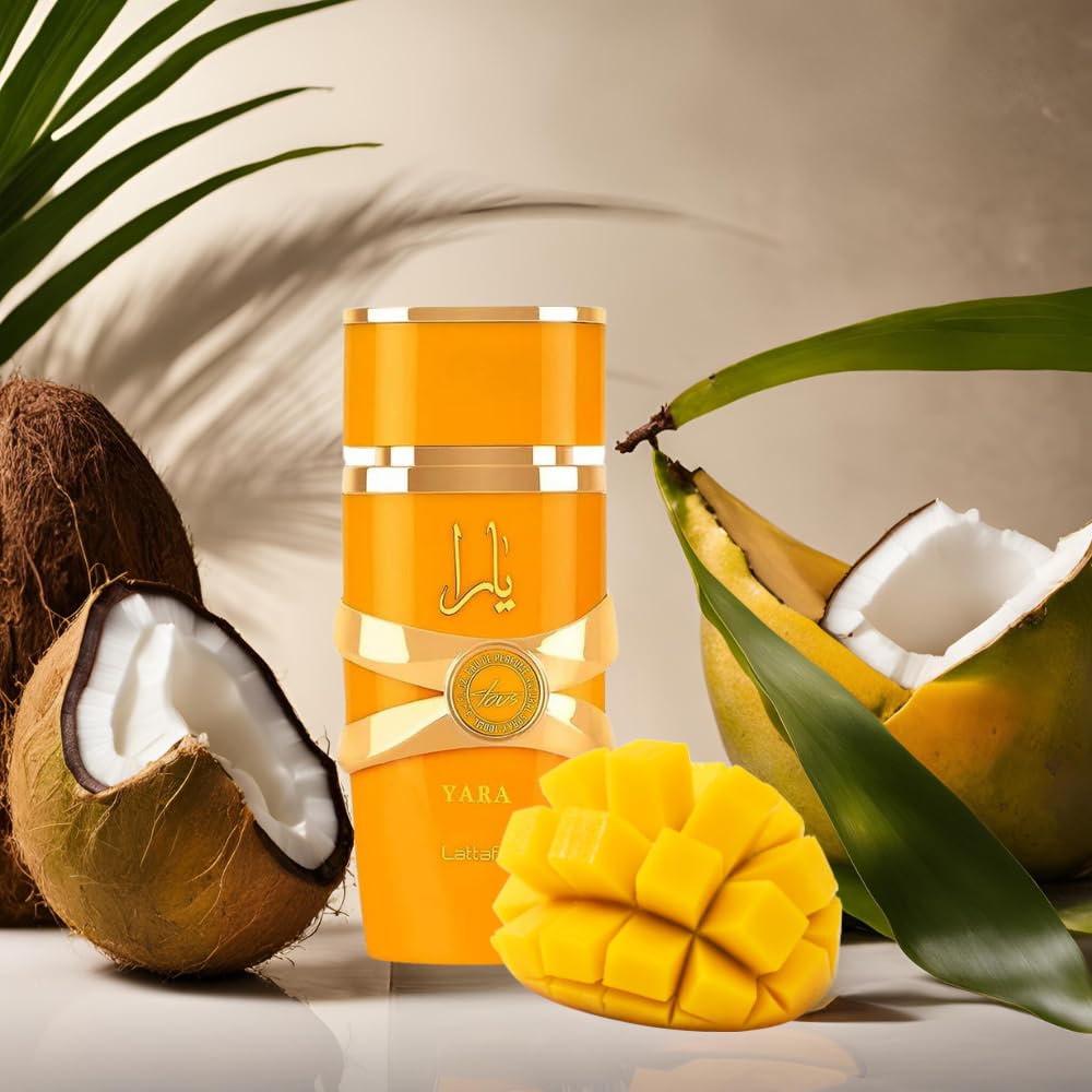 Lattafa Yara Tous perfume for women with mango and coconut fruits next to vibrant gold bottle