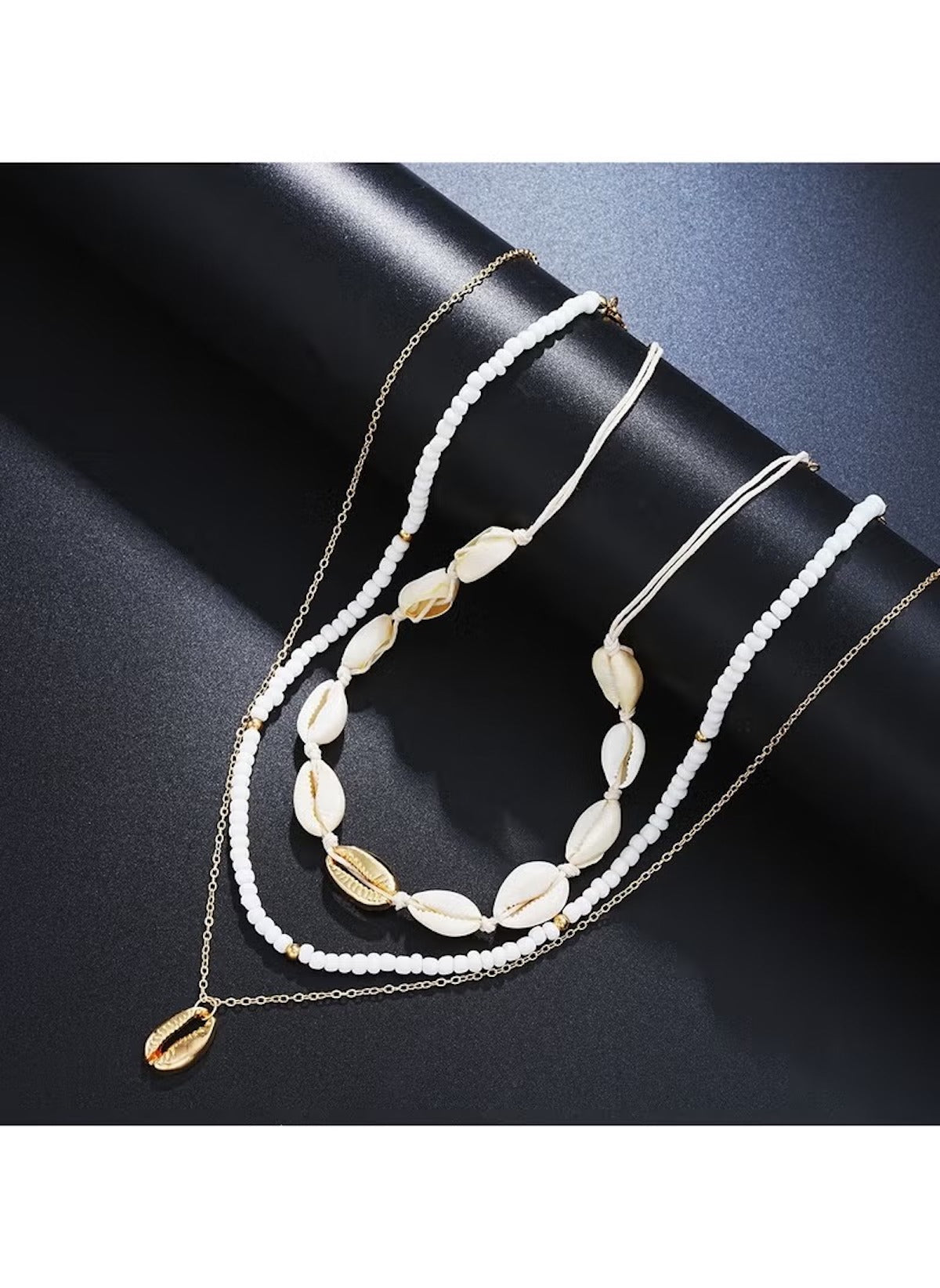 14 piece layered beach jewelry set featuring white beads and gold shell accents on chains