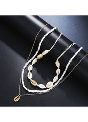 14 piece layered beach jewelry set featuring white beads and gold shell accents on chains