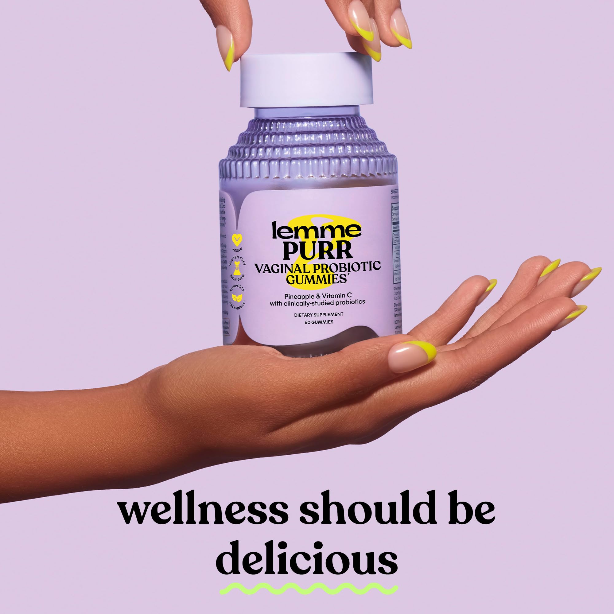 Lemme Purr vaginal probiotic gummies for women in a stylish bottle held in a hand, promoting feminine wellness