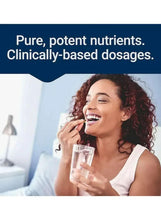 Woman smiling while drinking from a clear glass of water