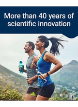 Two runners jogging while holding water bottles on a mountain trail