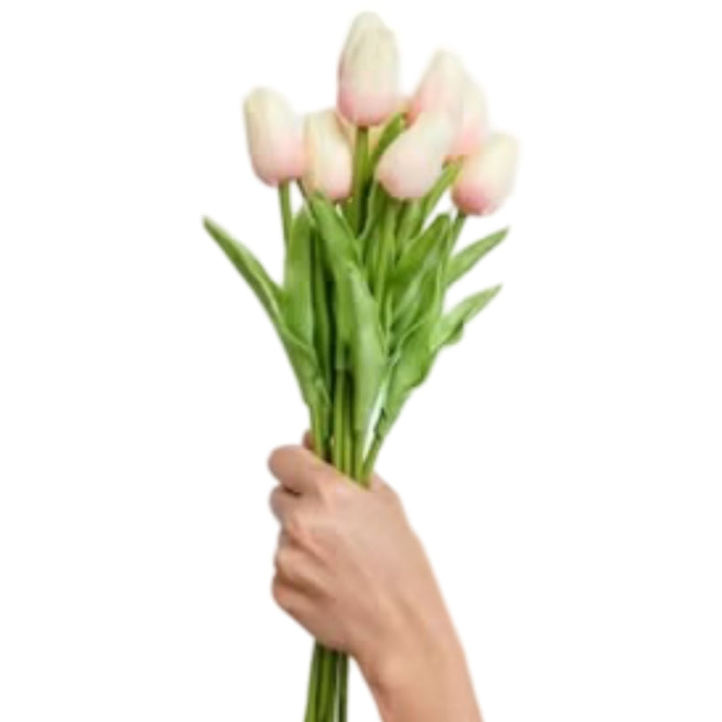 Hand holding light pink silk tulips bouquet with green stems and leaves by Huitich