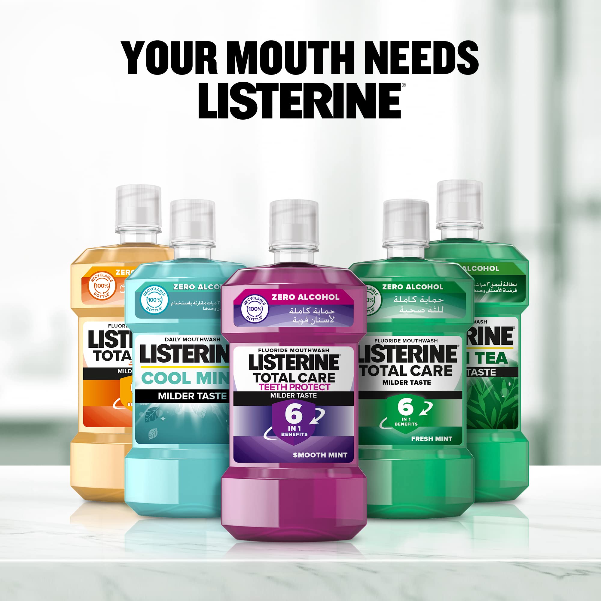 Row of Listerine mouthwash bottles on counter with Your Mouth Needs Listerine sign including Listerine Advanced White Mouthwash