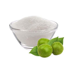 Glass bowl of light sweetener with fresh monk fruit halves and leaves