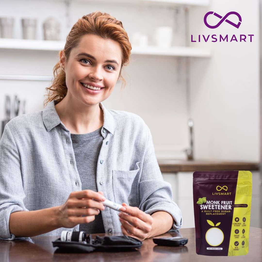 Livsmart monk fruit sweetener UAE pouch displayed beside smiling woman in a bright kitchen