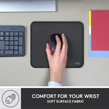 Black mouse pad on desk with hand using mouse, logi logo
