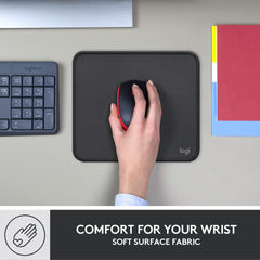 Logitech anti-slip computer mouse mat with soft surface fabric and wrist comfort holding a black and red mouse