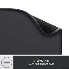 Corner of black mouse pad with stitched edge and textured underside, logi logo