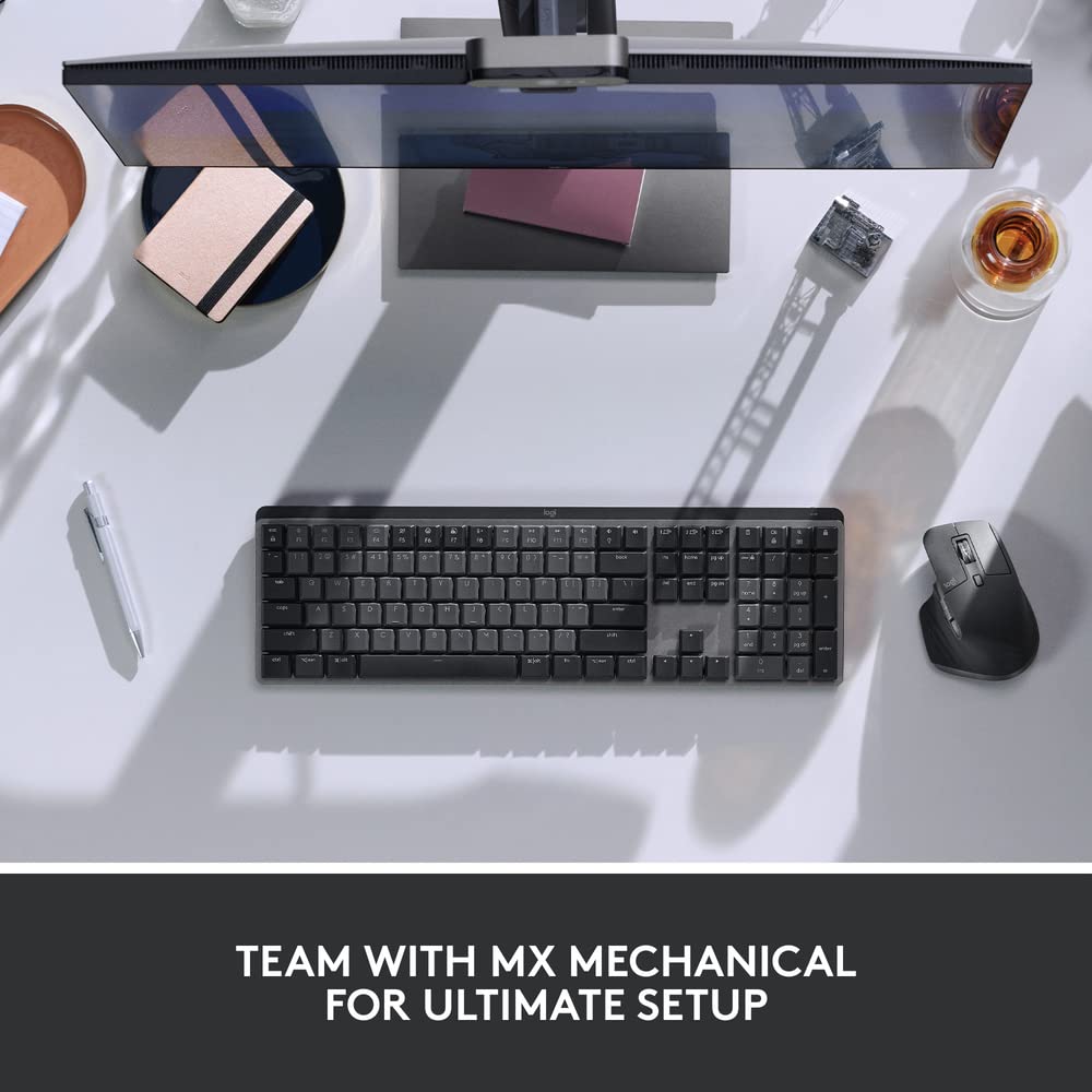 Logitech ergonomic mouse for productivity next to a mechanical keyboard and monitor on a clean desk setup