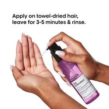 Hair serum sprayer applying product to towel-dried hands