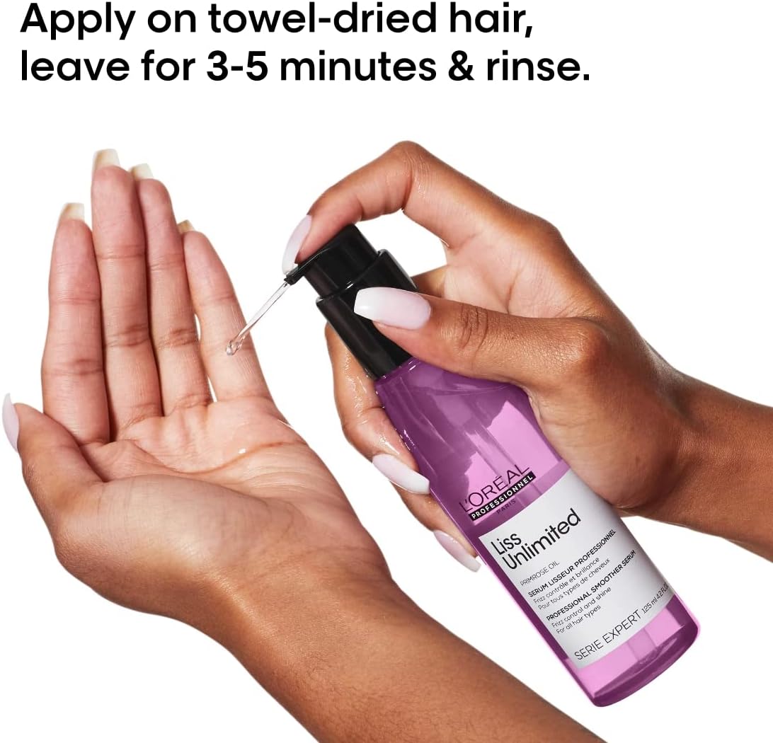 L'Oréal hair serum for frizzy hair in a hand, demonstrating application on towel-dried hair.