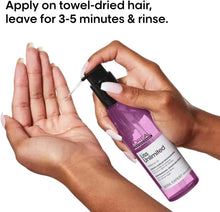 Hair serum applicator spritzing on towel-dried hands and hair