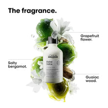 Shampoo bottle with black pump amid green and white splash with flowers