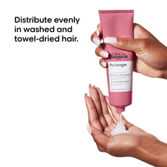 L'Oreal Pro Longer 10-in-1 cream for long hair being applied to towel-dried hair by a person