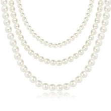 Multi-strand pearl necklace with three rows of round white pearls