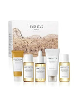 Centella travel skincare kit with yellow-and-white bottles, tubes, and outer box