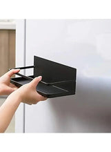 Black magnetic refrigerator organizer rack attached to fridge door with side lip