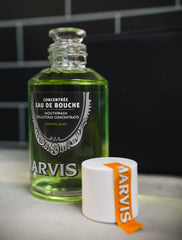 Marvis strong mint mouthwash glass bottle of concentrated green mouthwash with white cap and orange label