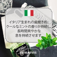 Marvis Whitening Mint Toothpaste tube with fresh mint leaves and towel styled bathroom flat lay