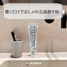 Marvis whitening mint toothpaste tube with toothbrush in a white cup
