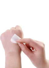Hand applying an alcohol swab pad to a fingertip