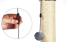 Cat scratching post with sisal pole and dangling gray ball toy on a short string