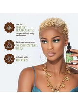 Scalp oil bottle with black dropper, held by a woman with curly hair