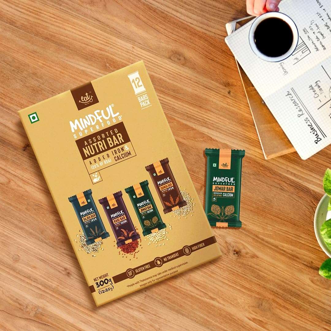 EAT Anytime Mindful Assorted NutriBar box with a green bar and coffee on wood table gluten free energy bars UAE