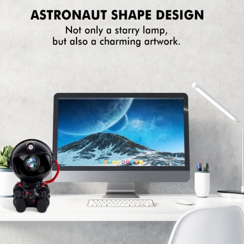 Huitich mini astronaut projector galaxy light on white desk next to computer with space background display