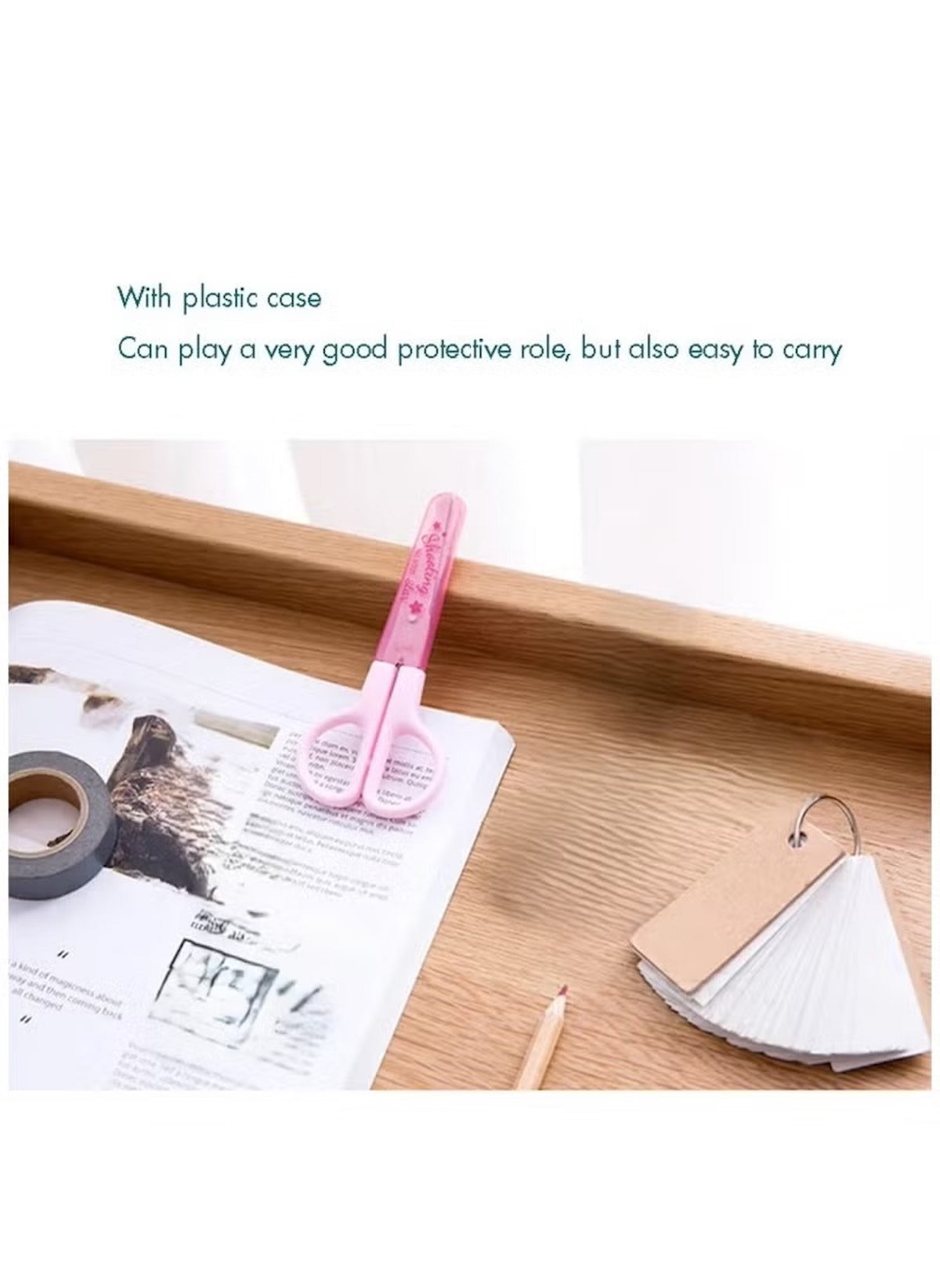 Huitich pink mini student safety scissors with plastic case on wooden desk near paper and tape