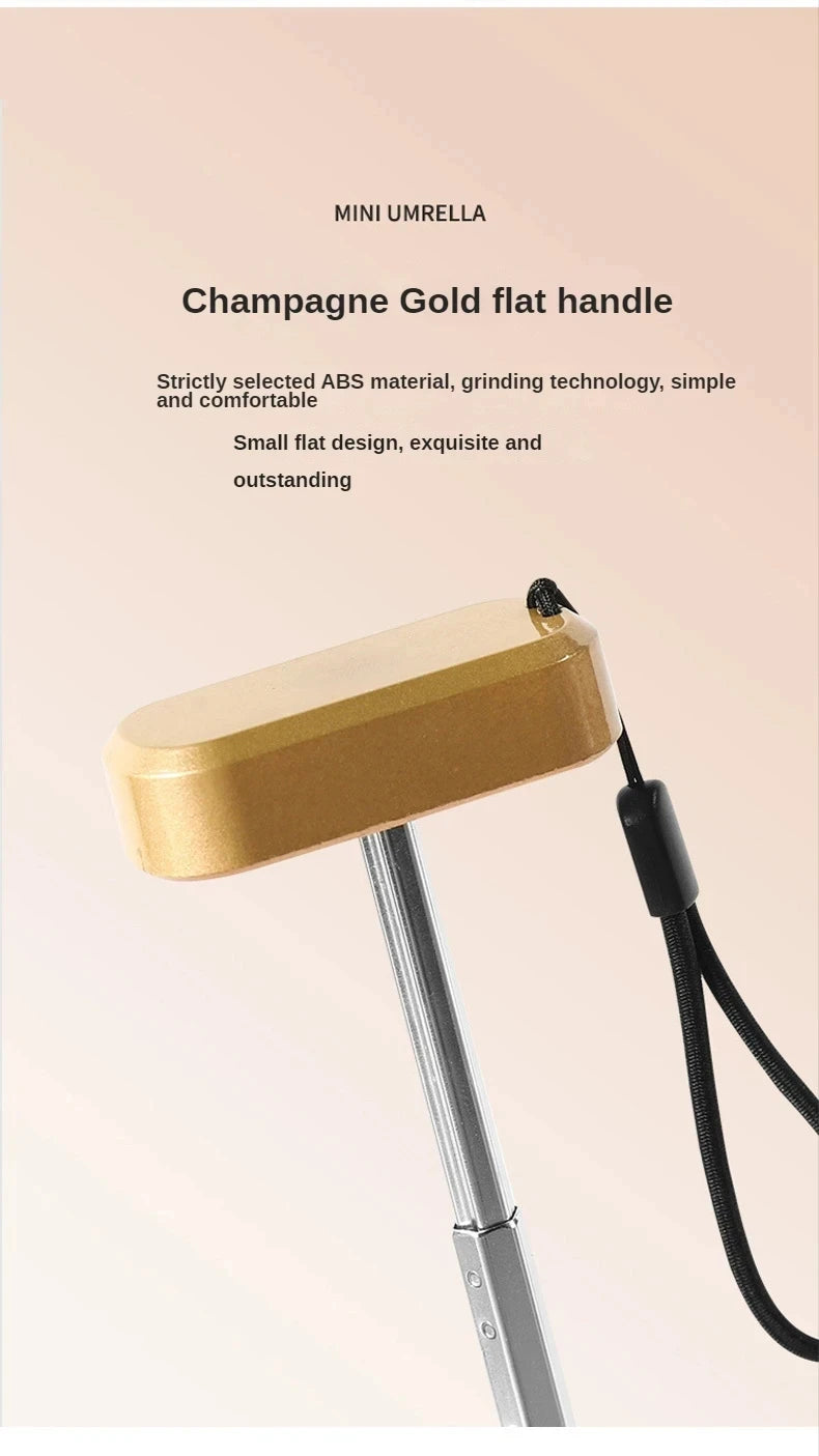 Mumzar mini sun umbrella pocket size with a champagne gold flat handle for easy carrying