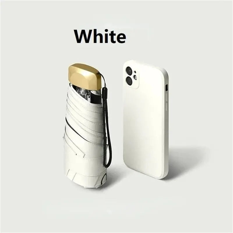 Mumzar mini sun umbrella pocket size alongside a white smartphone for compact portability