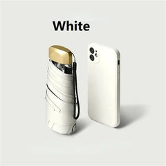 Mumzar mini sun umbrella pocket size alongside a white smartphone for compact portability