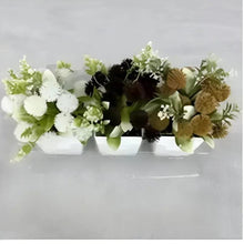 Artificial flower arrangement in white rectangular planter with mixed white, green and dark blooms
