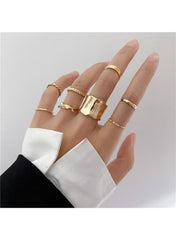 Minimalist gold ring set for women displayed on a hand with various styles and designs