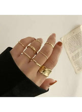 Minimalist gold-tone women’s ring set with layered slim bands and textured square ring