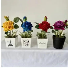 Purple artificial rose plant in black pot among other artificial roses in pots
