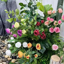 Artificial rose bouquet with pink and red blossoms plus yellow flowers, green foliage