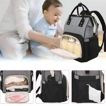 Grey and black baby travel bag open with light interior and shoulder strap